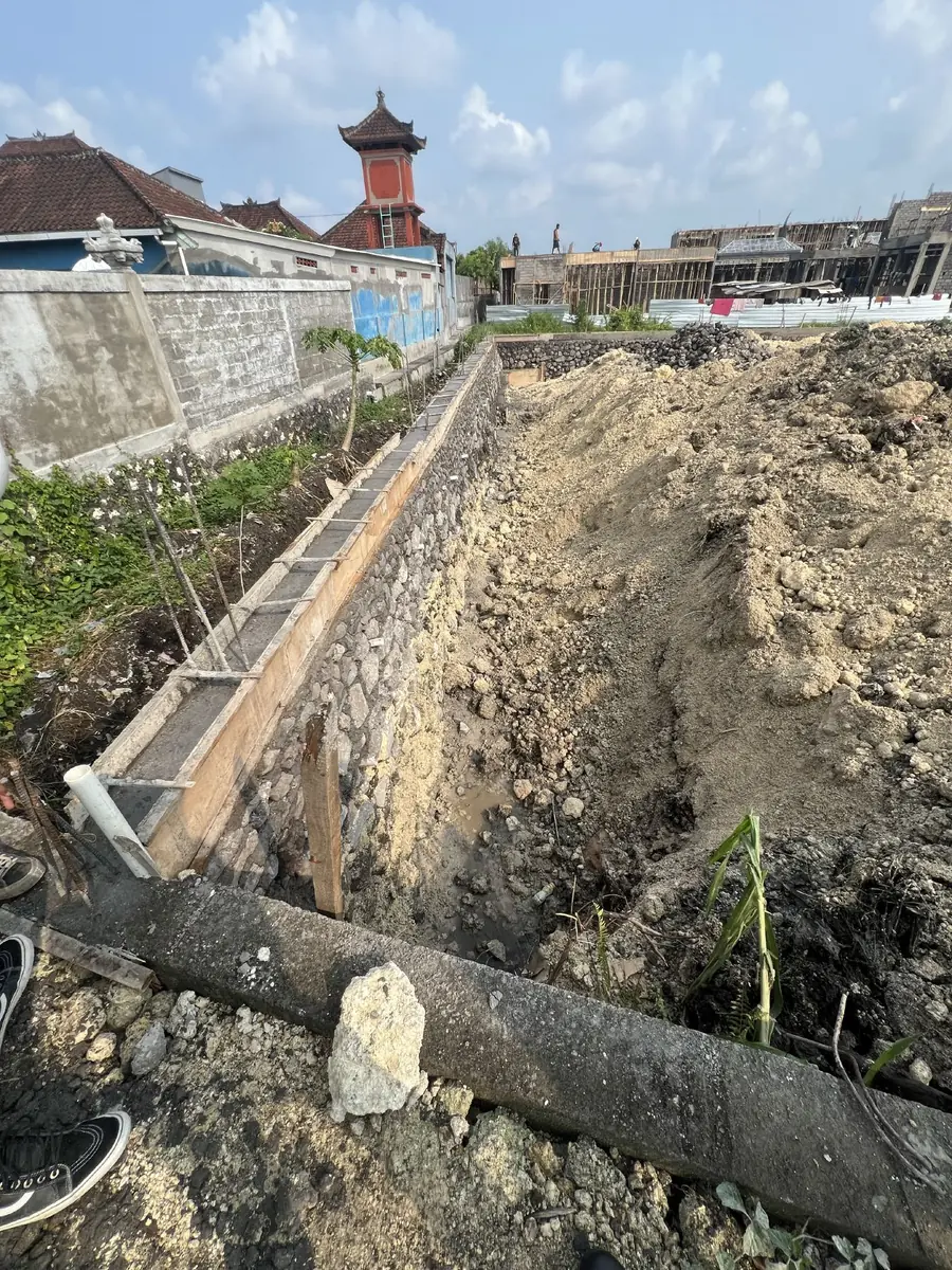 Stone retaining wall along the boundary